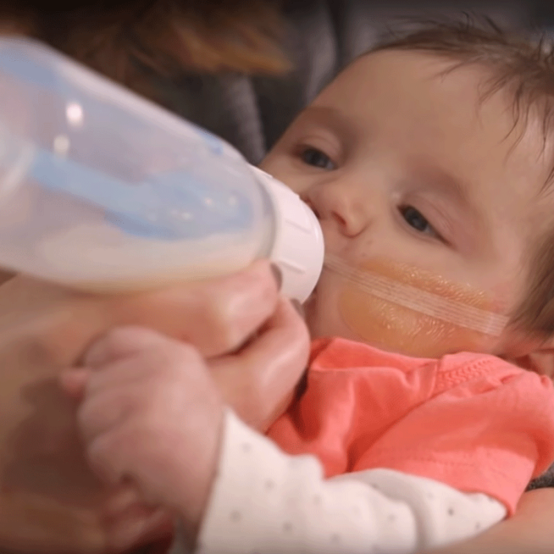 baby being fed with Dr. Brown's bottle