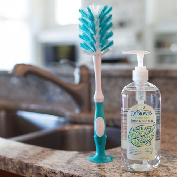 Deluxe bottle brush and dish liquid sitting on counter next to sink