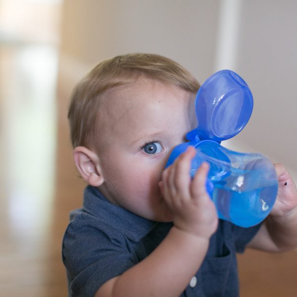 Baby drinking from blue cup