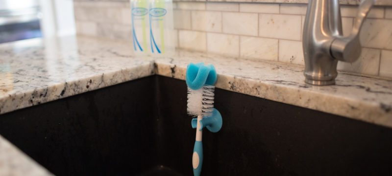 Bottle brush hanging inside kitchen sink