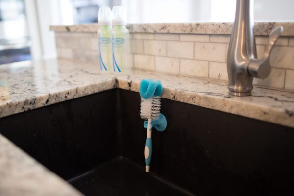 Bottle brush hanging inside kitchen sink